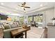 Bright living room featuring a tray ceiling, wood floors, and large sliding glass doors to the lanai at 5805 49Th E Ct, Ellenton, FL 34222