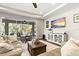 Bright living room with tile flooring, large sliding glass doors to the outside, and tray ceiling at 5805 49Th E Ct, Ellenton, FL 34222