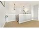 A loft space with neutral carpet, white walls, decorative art pieces, overhead lighting, and stair access to other floors at 5805 49Th E Ct, Ellenton, FL 34222