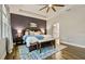 Bright and airy main bedroom with tray ceiling, wood floors, and a view of the en-suite bathroom at 5805 49Th E Ct, Ellenton, FL 34222