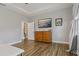 Main bedroom featuring wood floors, a dresser, and door leading to bathroom at 5805 49Th E Ct, Ellenton, FL 34222