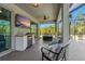 Cozy outdoor seating area featuring comfortable chairs, TV, and built-in bar for relaxation and entertaining at 5805 49Th E Ct, Ellenton, FL 34222