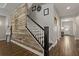 Elegant staircase featuring wood-look tile, decorative wall accents, and a painted handrail and banister at 5805 49Th E Ct, Ellenton, FL 34222