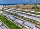 Scenic aerial shot of villas near the ocean with beachfront access and neatly arranged parking areas at 5858 Midnight Pass Rd # 27, Sarasota, FL 34242