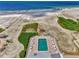 A resort-style pool with lounge chairs on sandy beach near condos, offering a perfect vacation getaway at 5858 Midnight Pass Rd # 27, Sarasota, FL 34242