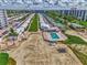 Aerial view featuring well-maintained villas with a community pool, beachfront access and a gazebo on a sunny day at 5858 Midnight Pass Rd # 27, Sarasota, FL 34242