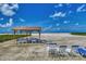 Beachside gazebo with seating, providing a relaxing spot to enjoy views of the beach and ocean at 5858 Midnight Pass Rd # 27, Sarasota, FL 34242