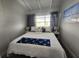 Bedroom with a queen-sized bed, nautical decor, and soft, neutral colors at 5858 Midnight Pass Rd # 27, Sarasota, FL 34242