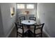 Cozy breakfast nook with a round table and seating for four near a window at 5858 Midnight Pass Rd # 27, Sarasota, FL 34242