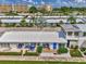 Charming villa featuring a covered patio with blue furniture and a well-maintained landscape at 5858 Midnight Pass Rd # 27, Sarasota, FL 34242