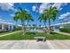 Well-kept villas facing a tranquil water feature, accented by symmetrical palms and manicured lawns at 5858 Midnight Pass Rd # 27, Sarasota, FL 34242