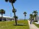 Quaint villas lined along a sidewalk with palm trees, offering a tranquil path to the nearby beach at 5858 Midnight Pass Rd # 27, Sarasota, FL 34242