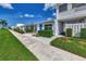 Inviting villa showcasing a bright blue front door, lush landscaping, and a convenient carport at 5858 Midnight Pass Rd # 27, Sarasota, FL 34242