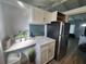 Kitchen featuring stainless steel refrigerator, white cabinets, and quartz countertops at 5858 Midnight Pass Rd # 27, Sarasota, FL 34242