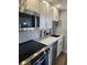 Modern kitchen featuring stainless steel appliances, white cabinets, and quartz countertops at 5858 Midnight Pass Rd # 27, Sarasota, FL 34242