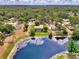 Aerial view of the property showcasing a large backyard, private pool, and lake access at 6011 91St E St, Bradenton, FL 34202