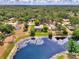 Aerial view of home with pool, lush greenery, lake, and natural surroundings at 6011 91St E St, Bradenton, FL 34202