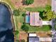 Overhead view of home near waterfront, pool, lush backyard and mature trees at 6011 91St E St, Bradenton, FL 34202