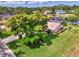 Aerial view of home featuring a lush yard, mature trees, screen enclosed lanai and water views at 6011 91St E St, Bradenton, FL 34202