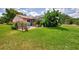 Beautifully landscaped backyard with a cozy patio area and lush green grass at 6011 91St E St, Bradenton, FL 34202