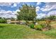 Expansive backyard with lush lawn, mature trees, and a tranquil water view at 6011 91St E St, Bradenton, FL 34202