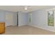 Spacious bedroom features tile flooring, light blue walls, ceiling fan, and natural light from two windows at 6011 91St E St, Bradenton, FL 34202