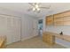 Spare bedroom with neutral colors, built in shelves, ceiling fan, and outdoor access at 6011 91St E St, Bradenton, FL 34202
