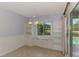 Dining area with built-in shelves and cabinets, with view of the pool area at 6011 91St E St, Bradenton, FL 34202