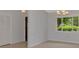 Tile floor hallway with a large closet and window showcasing the lush greenery of the landscape at 6011 91St E St, Bradenton, FL 34202