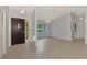 Inviting foyer with neutral tile, and view of the front door, dining and living areas at 6011 91St E St, Bradenton, FL 34202