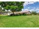 Charming single-story home with lush lawn, mature shade tree, and manicured landscaping enhance curb appeal at 6011 91St E St, Bradenton, FL 34202