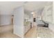 Well-lit kitchen with white cabinets, stainless appliances and speckled granite countertops and tile floors at 6011 91St E St, Bradenton, FL 34202