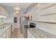 Modern kitchen features stainless steel appliances, granite countertops, and bright white cabinets at 6011 91St E St, Bradenton, FL 34202