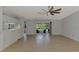 Open-concept living room with tile flooring and sliding glass doors leading to outdoor space at 6011 91St E St, Bradenton, FL 34202