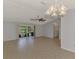 Bright living room with tile flooring, ceiling fan, and sliding glass doors to the pool at 6011 91St E St, Bradenton, FL 34202
