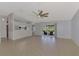 Bright living room with tile flooring, ceiling fan, and sliding glass doors to the pool at 6011 91St E St, Bradenton, FL 34202