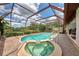 Inviting screened-in pool and spa, perfect for year-round enjoyment and relaxation at 6011 91St E St, Bradenton, FL 34202