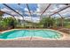 Beautiful screened pool with tropical foliage, offering privacy and a relaxing outdoor oasis at 6011 91St E St, Bradenton, FL 34202