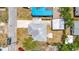 Bird's-eye view of the property showing roof, driveway, carport, and surrounding neighborhood at 609 25Th W Ave, Bradenton, FL 34205