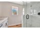 Modern bathroom featuring stylish white vanity, wood floors and a glass enclosed shower at 609 25Th W Ave, Bradenton, FL 34205