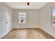 Bedroom featuring hardwood floors, neutral walls, white trim, and a large window at 609 25Th W Ave, Bradenton, FL 34205