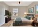 Staged bedroom featuring hardwood floors, neutral walls, white trim, and a large window at 609 25Th W Ave, Bradenton, FL 34205