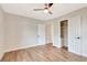 Bedroom featuring hardwood floors, neutral walls, white trim, a ceiling fan and a closet at 609 25Th W Ave, Bradenton, FL 34205