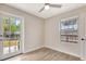 Bright bedroom with a ceiling fan, wood-look floors, large window and direct access to the backyard at 609 25Th W Ave, Bradenton, FL 34205