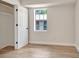Bright bedroom with light-colored laminate flooring, fresh paint, closet, and natural light at 609 25Th W Ave, Bradenton, FL 34205
