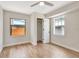 Bedroom with light-colored laminate flooring, closet, white trim, and two windows at 609 25Th W Ave, Bradenton, FL 34205