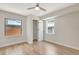 Bright bedroom with wood-look floors, two windows, a ceiling fan and an open closet at 609 25Th W Ave, Bradenton, FL 34205