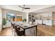 Dining room featuring hardwood floors, neutral walls and bright light flowing in to an open concept kitchen at 609 25Th W Ave, Bradenton, FL 34205