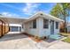 Home exterior featuring a covered carport, garden bed, and well-maintained curb appeal at 609 25Th W Ave, Bradenton, FL 34205
