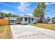 Wide view of home with a driveway and covered parking to the left; note front windows and door at 609 25Th W Ave, Bradenton, FL 34205